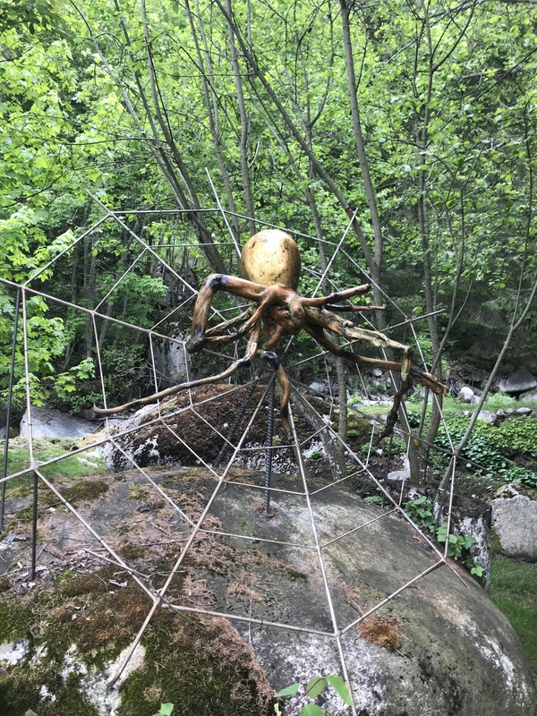 Sculpture d'araignée sur sa toile, au cœur de la forêt. 